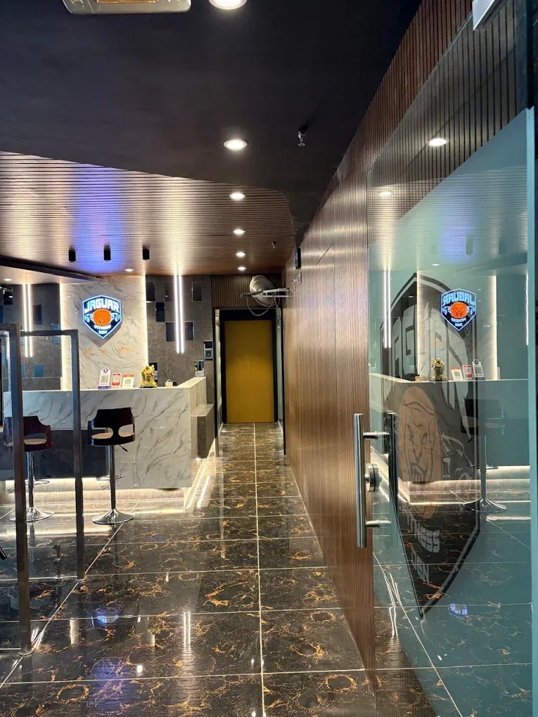Glass entrance and corridor leading to the Jaguar Fitness Den reception